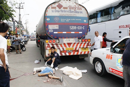 The victim of the road traffic accident lies prostrate next to the fuel tanker with which he collided on his motorcycle in Naklua, Thursday, March 30.